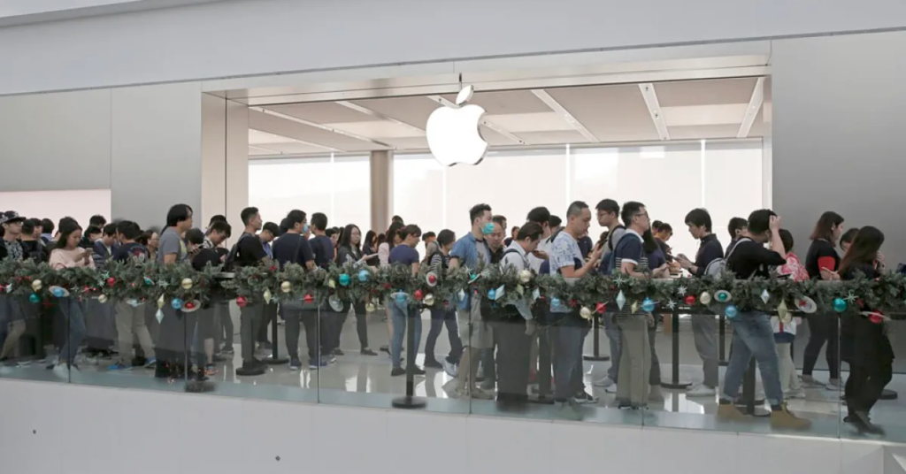 Apple customers waiting in line in front of the store